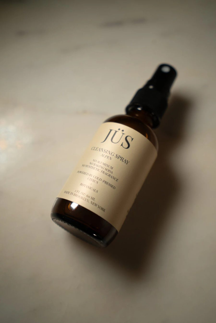 JÜS Alpen Cleansing Spray bottle on alpine stone